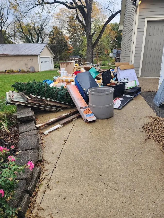 Dumpster being loaded with debris for 3 Yard Dumpster Rental in Hillsdale